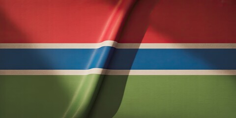 Waving Gambia national flag close up textured fabric background vibrant red blue green stripes patriotic banner concept