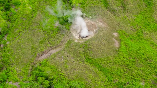 Steaming fumarole in the crater of the Taal volcano. Geothermal volcanic activity, top view. Tagaytay, Philippines.