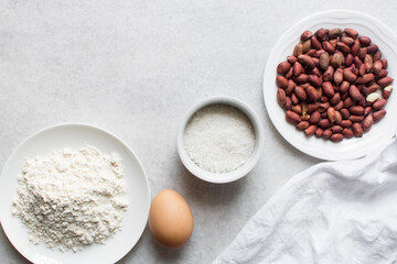 overhead view of mise en place of ingredients for making coated peanuts, process of making nigerian coated peanuts or cracker nut