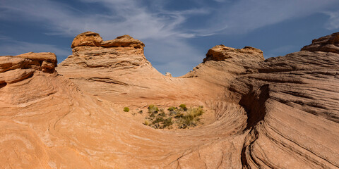 Beehive and New Wave trails in Glen Canyon National Recreation Area near Page, Arizona. Sandstone outcroppings, windswept rock formations, breathtaking views of desert landscape and distant mountains.