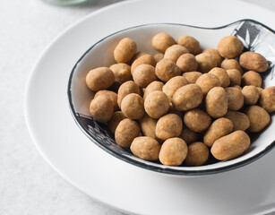 Coated peanuts or cracker peanuts on a white granite countertop