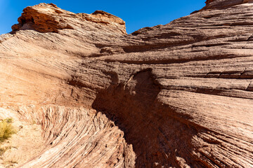 Beehive and New Wave trails in Glen Canyon National Recreation Area near Page, Arizona. Sandstone outcroppings, windswept rock formations, breathtaking views of desert landscape and distant mountains.