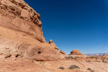 Fototapeta premium Beehive and New Wave trails in Glen Canyon National Recreation Area near Page, Arizona. Sandstone outcroppings, windswept rock formations, breathtaking views of desert landscape and distant mountains.