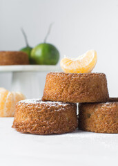 close up view of mini citrus bundtlette cakes on a white countertop, mini citrus bundt cakes on a white background
