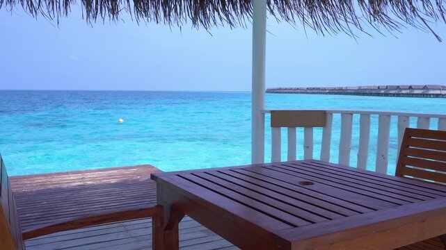 Summer house with table and chairs at seaside. Travel destination. Nobody