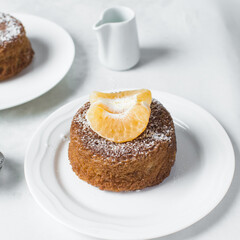 close up view of mini citrus cakes on a white countertop, mini citrus bundt cakes on a white background