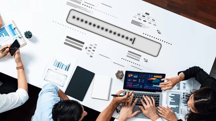 A diverse group of professionals collaborates on a data analysis project, using a laptop and digital tools to visualize business insights in a modern office setting. Raster