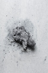 Overhead view of squid ink pasta  dough being made on a white granite countertop, process of making homemade black spaghetti