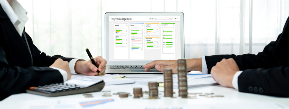 Project planning software for brisk business project management on the computer screen showing timeline chart of the team project