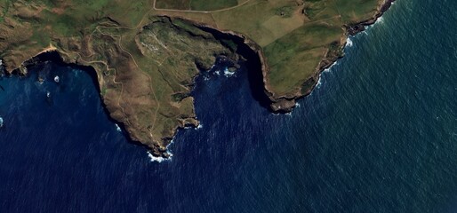 Stunning Aerial View of Rugged New Zealand Coastline Meeting Deep Blue Ocean