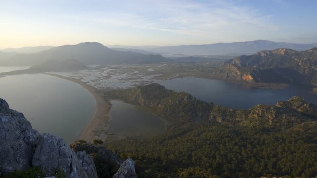 Dalyan river delta and Iztuzu beach merging with the sea, seen from a mountain top at sunset
