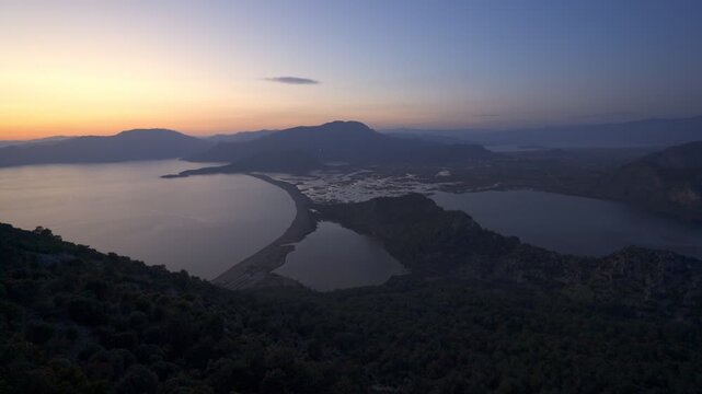 Dalyan river delta and Iztuzu beach merging with the sea, seen from a mountain top at sunset