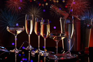 New Year greeting card with glasses of sparkling wine, fireworks and bokeh lights