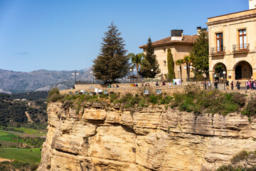 Ronda viewpoint showing people enjoying cliffside landscape in Andalusia, Spain