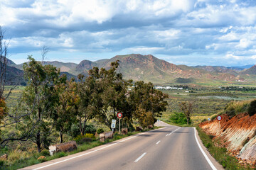 Winding road through Andalusia mountains leading to the coast in Spain