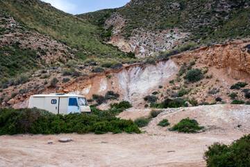 Camper van parked in a remote wild landscape exploring nature in Cabo de Gata, Spain