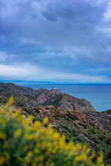 Cabo de Gata Nijar Natural Park rocky coastline under cloudy sky at sunset in Spain