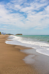 Bolnuevo beach coastline with blue sky and white clouds above th