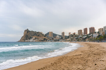 Benidorm beach with hotels on a cloudy day, in Spain
