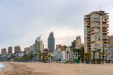 Benidorm beach with hotels on a cloudy day, in Spain