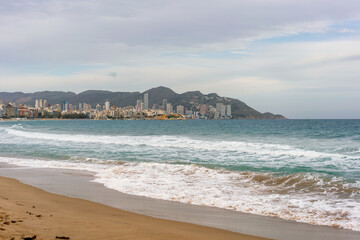 Benidorm beach with hotels on a cloudy day, in Spain