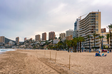 Benidorm beach with hotels on a cloudy day, in Spain