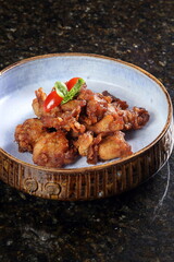 Karaage, Japanese fried chicken with boneless chicken thigh, garlic cloves, ginger, scallions, lemon, cornstarch, dry sake, soy sauce, salt and pepper to taste.