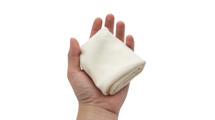 A hand holding a folded piece of white fabric with soft folds and gentle curves isolated on a transparent background