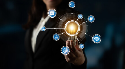A businesswoman holds a glowing light bulb, surrounded by digital network symbols, representing creativity and innovation in modern technology and communication. Crux