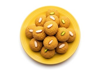 Authentic indian boondi ladoo sweets on a yellow plate, top view