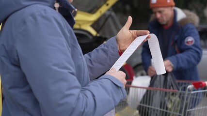 Family grocery shopping together. Receipt from the supermarket. Expenditure household on groceries. Household budget - Powered by Adobe