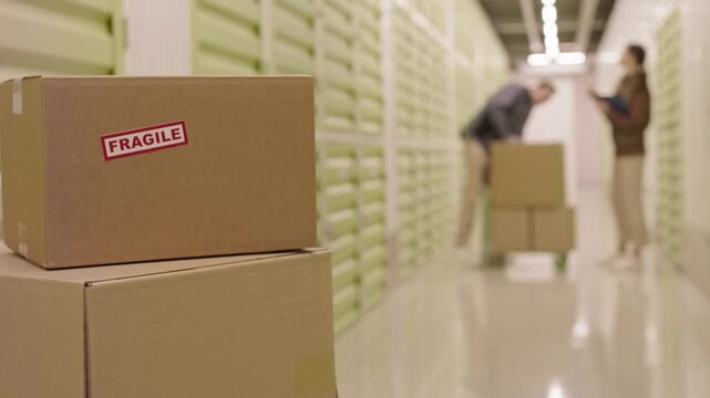 Fragile Package Ready for Shipment in Busy Warehouse Hallway