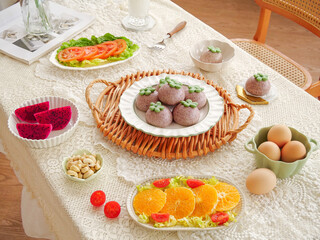 Traditional healthy breakfast table with fresh fruits vegetables eggs and delicious homemade treats in natural sunshine lighting