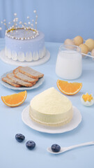 Fresh white cheese wheel with blueberries milk and breakfast foods on blue background