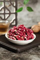 Red-skinned Xinjiang walnut kernels in bowl - premium nuts rich in healthy fats for cooking and snacking