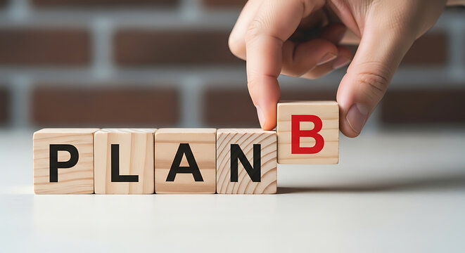Hand adding ' B' block to spell PLANB plan b strategy