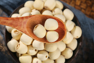 Dried White Lotus Seeds in Wooden Spoon - Nutritious Asian Superfood Ingredients for Healthy Cooking