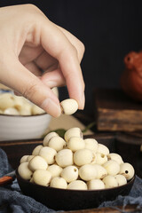 Hand Picking Dried White Lotus Seeds - Nutritious Asian Superfood Ingredients for Healthy Cooking