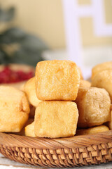 Crispy Golden Tofu Puffs in Wicker Basket - Fried Soy Bean Cubes for Asian Cooking