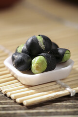 Black Beans with Green Hearts in White Bowl on Bamboo Mat - Healthy Asian Food Ingredient