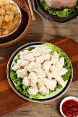Crispy Golden Chicken Nuggets Platter with Fried Cauliflower and Sauce on Wooden Table