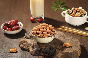 Healthy nuts almonds dates milk rustic wooden background nutritious snack variety natural organic food ingredients