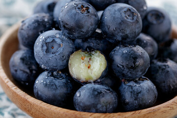 Fresh Nutritious Blueberries with Water Droplets in Wooden Bowl - Healthy Berry Superfood