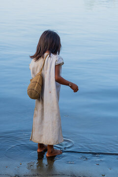 Indigenous Kogui child in traditional white clothing walking in the Sierra Nevada de Santa Marta mountains