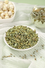 Dried Lotus Flower Tea Leaves with Jasmine in White Bowl - Traditional Herbal Tea Ingredients