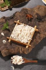 Dried Sea Shrimp from Beihai in Bamboo Basket with Spices on Rustic Wood Background