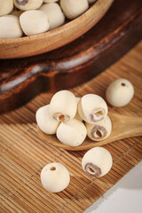 Dried White Coreless Lotus Seeds on Bamboo Mat - Healthy Asian Superfood Ingredient
