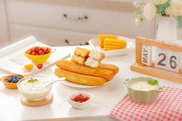 Delicious Afternoon Tea with Golden Pastries and Fresh Treats on Sunny May Morning