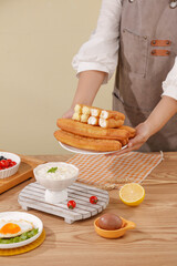 Chef Serving Delicious Golden Pancakes with Cottage Cheese for Healthy Breakfast Set in Bright Kitchen