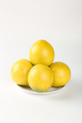 Fresh Yellow Lemons on White Plate - Citrus Fruit Still Life Photography